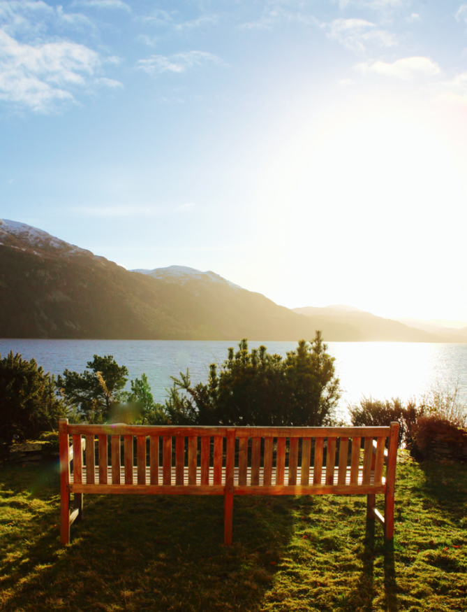 Large wooden bench on private grounds overlooking Loch Ness
